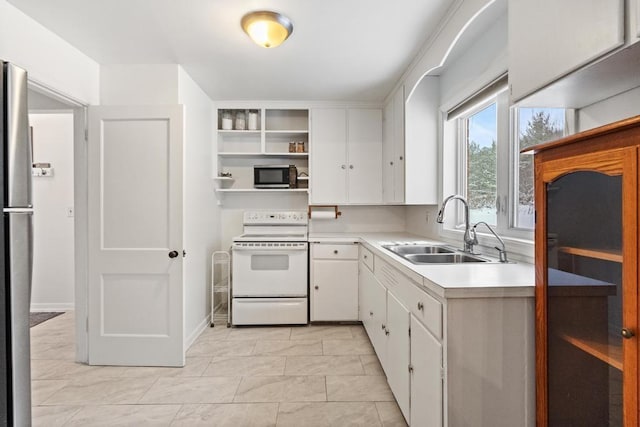 kitchen featuring white cabinets, light tile patterned floors, stainless steel appliances, and sink