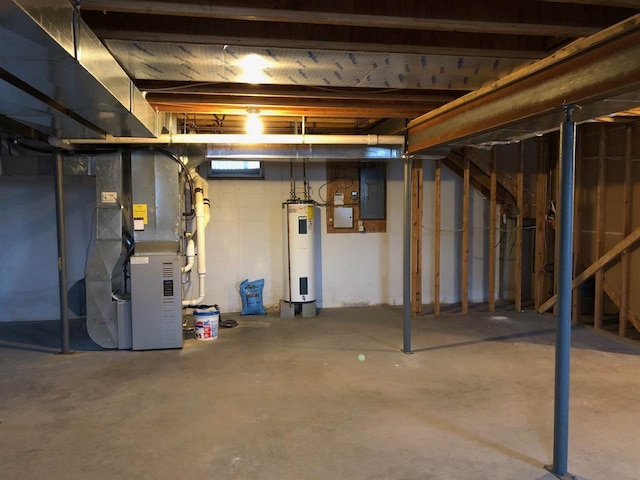 basement featuring electric water heater, electric panel, and heating unit