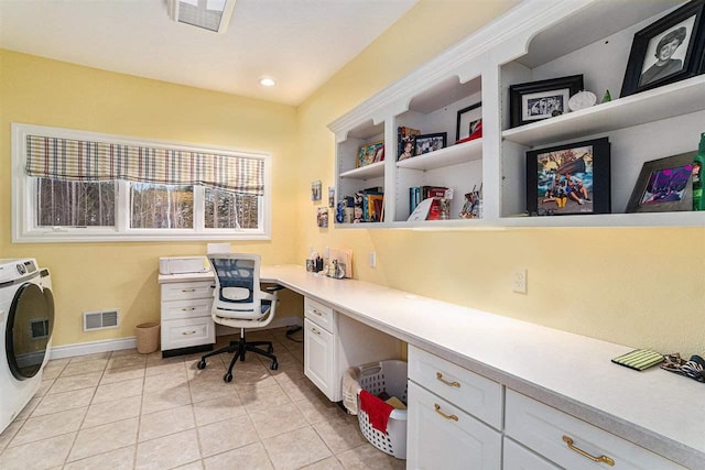 tiled office featuring built in desk and separate washer and dryer