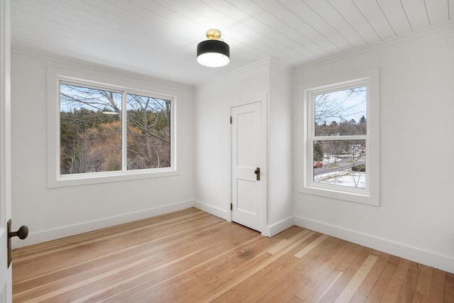 unfurnished room featuring light wood-type flooring and crown molding