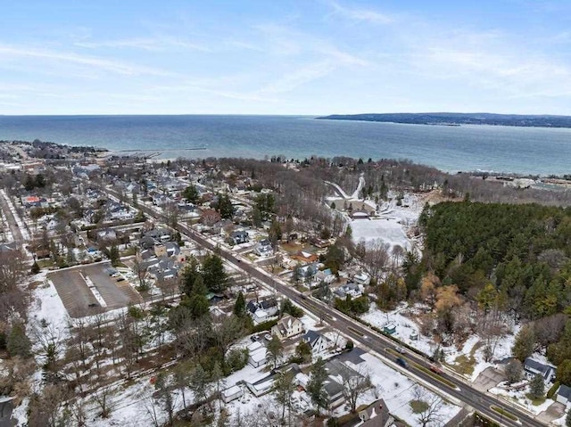 snowy aerial view with a water view