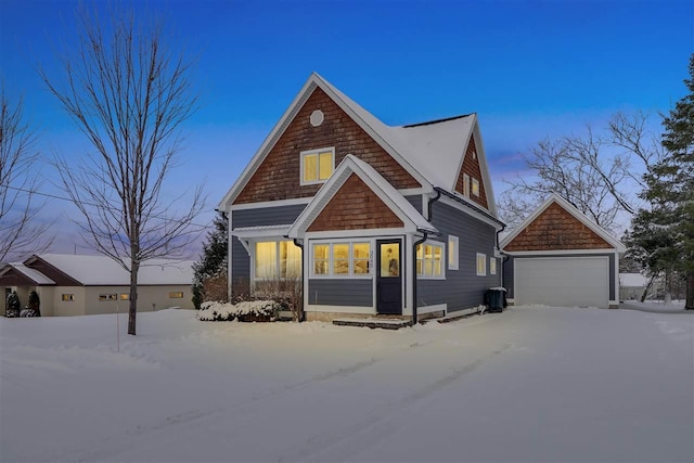 view of front facade featuring a garage and an outdoor structure