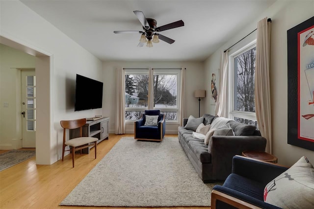 living room with ceiling fan and light hardwood / wood-style flooring