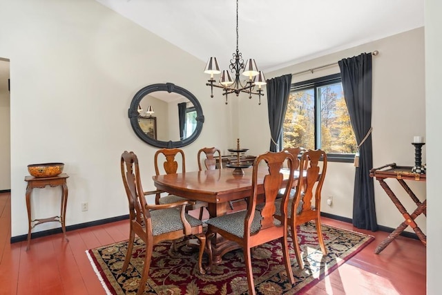 dining area featuring an inviting chandelier and hardwood / wood-style flooring