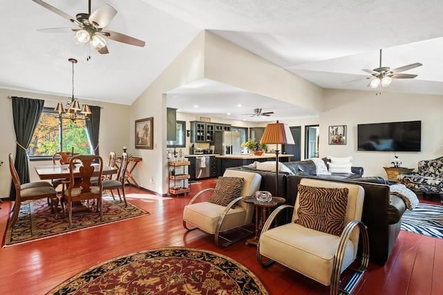 living room featuring a chandelier, wood-type flooring, and lofted ceiling