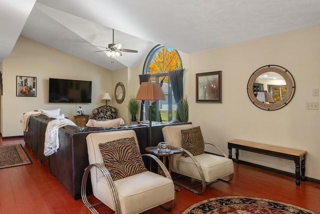 living room featuring hardwood / wood-style flooring, ceiling fan, and vaulted ceiling