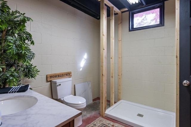 bathroom with toilet, vanity, concrete floors, and walk in shower