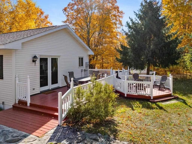 wooden deck featuring a yard