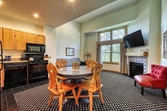 dining space featuring a tile fireplace