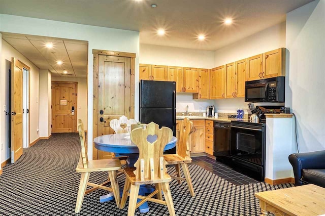 kitchen featuring light brown cabinets, black appliances, and sink