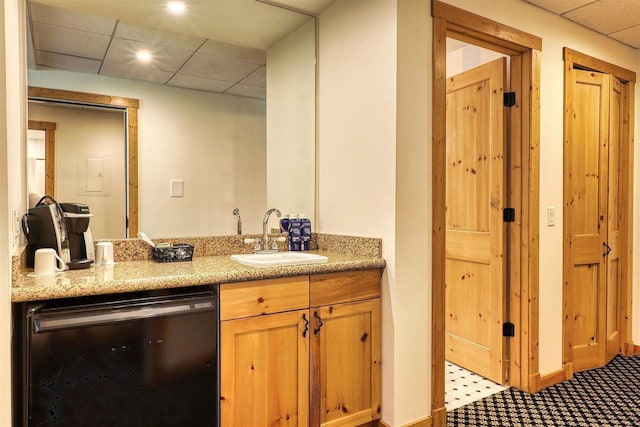 bathroom featuring a drop ceiling and vanity