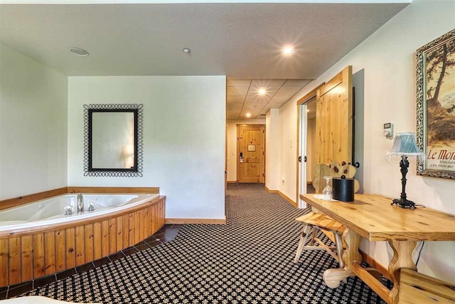 bathroom featuring tile patterned floors and a bath