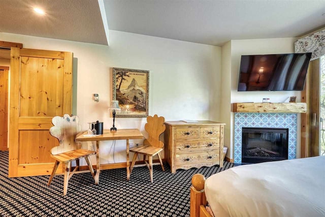 carpeted bedroom featuring a fireplace