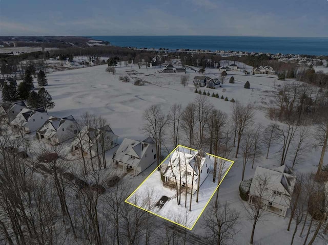 snowy aerial view with a water view