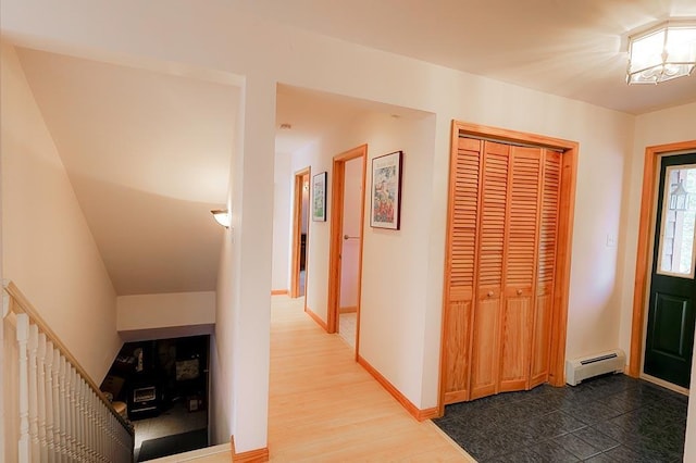 hallway with hardwood / wood-style flooring, a notable chandelier, and a baseboard radiator