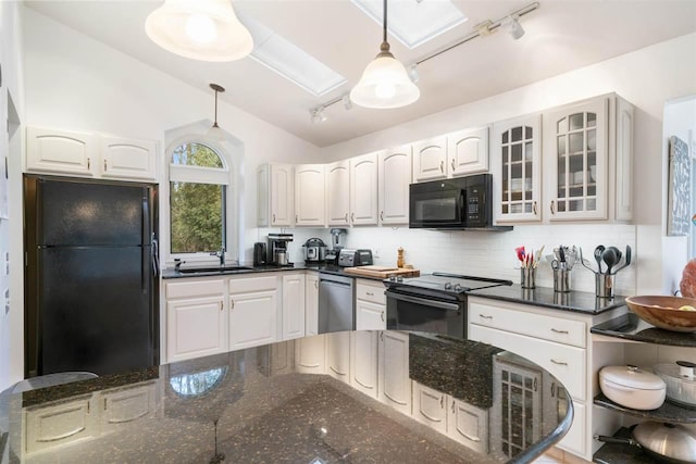 kitchen featuring white cabinetry, sink, hanging light fixtures, decorative backsplash, and black appliances