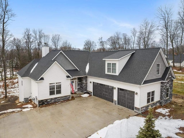 view of front of property with a garage and central air condition unit