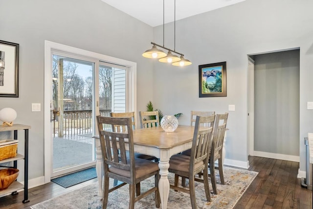 dining space with dark hardwood / wood-style flooring