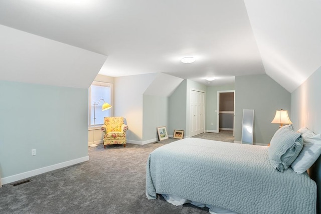 carpeted bedroom featuring a closet and lofted ceiling