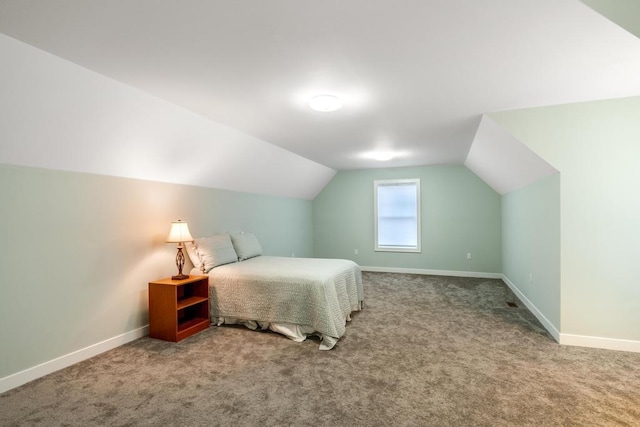 carpeted bedroom featuring lofted ceiling