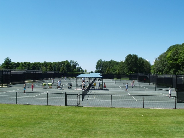 view of tennis court featuring a yard