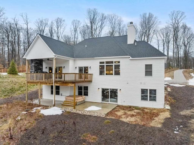 rear view of property featuring a wooden deck, ceiling fan, and a patio