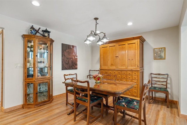 dining area featuring a notable chandelier and light hardwood / wood-style floors