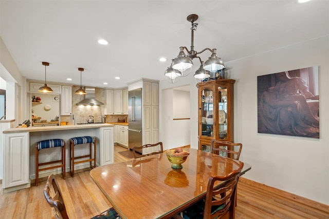 dining room featuring a chandelier and light hardwood / wood-style floors