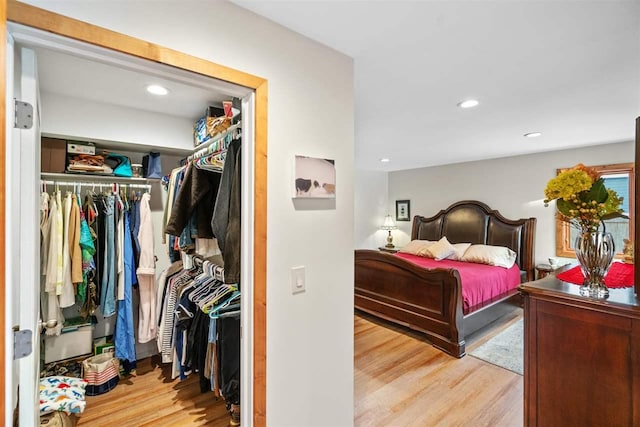 bedroom with light wood-type flooring and a closet