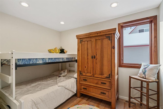 bedroom with hardwood / wood-style flooring