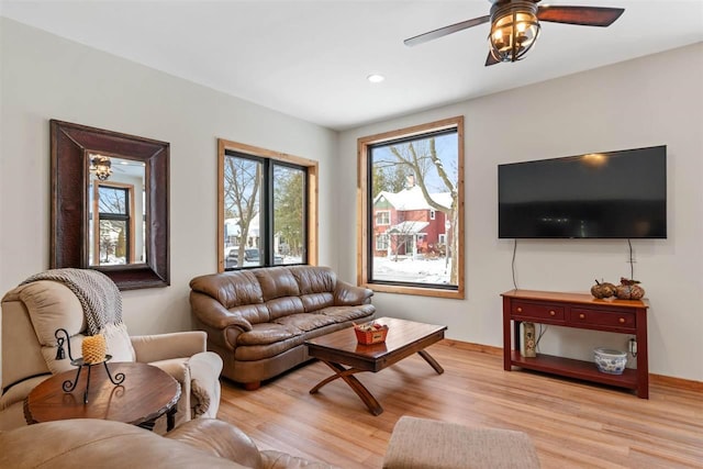 living room with ceiling fan and light wood-type flooring