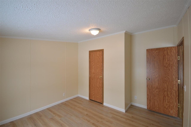 unfurnished room with a textured ceiling, light hardwood / wood-style flooring, and crown molding