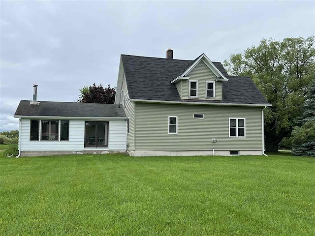 rear view of house with a yard