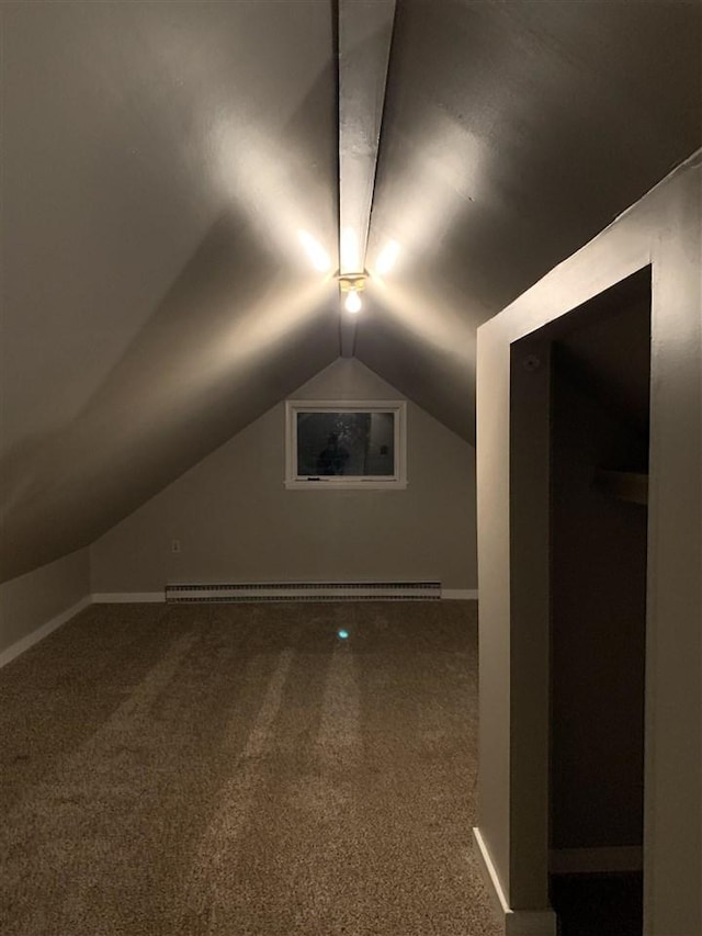 additional living space featuring carpet, a baseboard heating unit, and vaulted ceiling