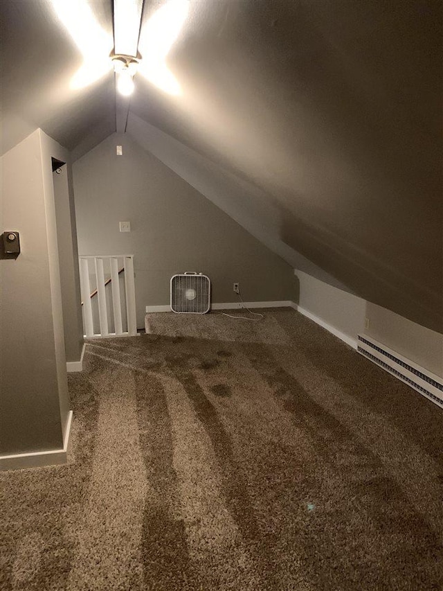 bonus room featuring carpet, lofted ceiling, and a baseboard heating unit