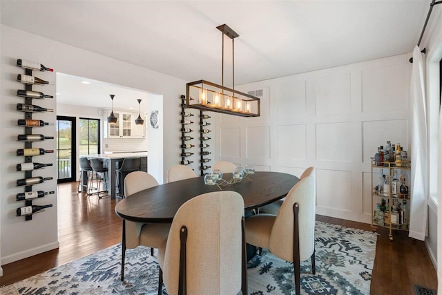 dining area featuring a chandelier and dark hardwood / wood-style floors