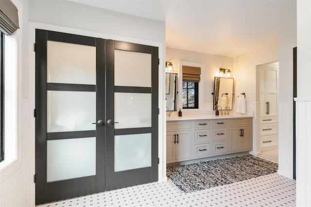 bathroom featuring french doors and vanity