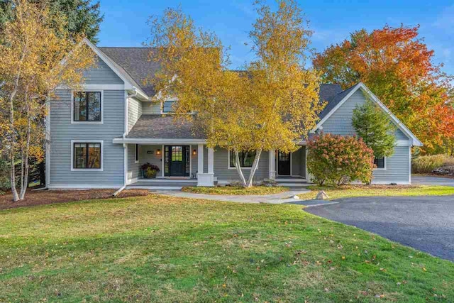 obstructed view of property featuring a front lawn