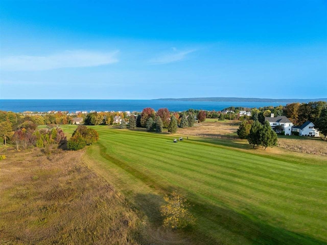 view of property's community featuring a lawn and a water view