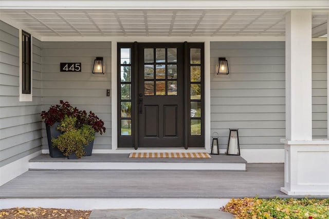 view of exterior entry featuring a porch