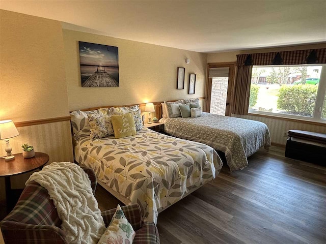 bedroom with dark hardwood / wood-style floors