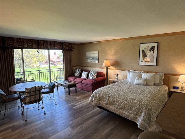 bedroom featuring access to outside, crown molding, and wood-type flooring