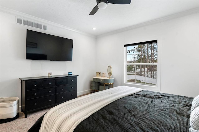 carpeted bedroom with ceiling fan and crown molding