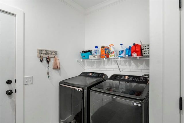 laundry area with separate washer and dryer and ornamental molding