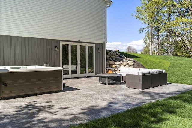 view of patio / terrace with french doors and a hot tub