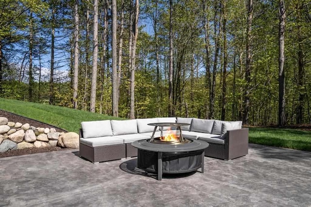 view of patio / terrace with an outdoor living space with a fire pit