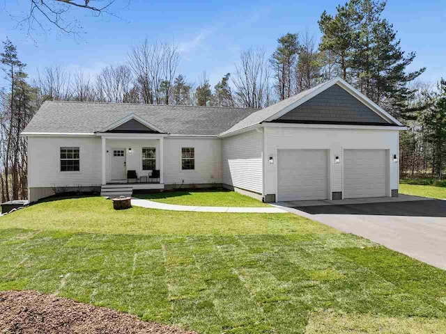 ranch-style house featuring covered porch, a garage, and a front yard