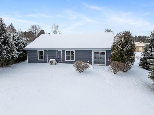 view of snow covered rear of property