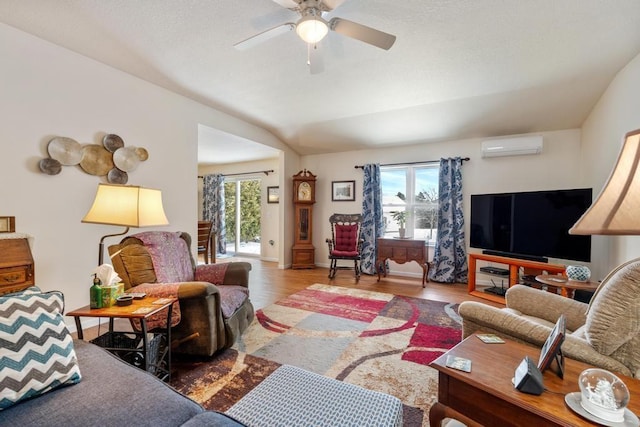 living room featuring hardwood / wood-style flooring, ceiling fan, a healthy amount of sunlight, and a wall mounted AC