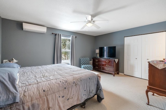 bedroom featuring ceiling fan, a closet, light carpet, and a wall mounted AC